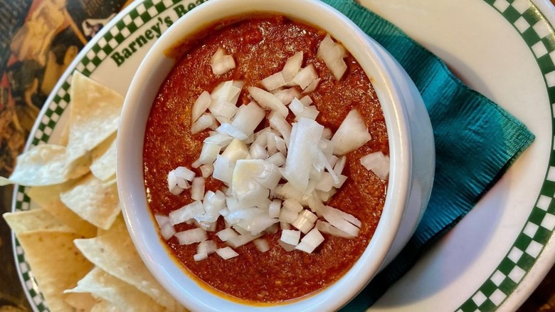 Bowl of chili with onions tortilla chips