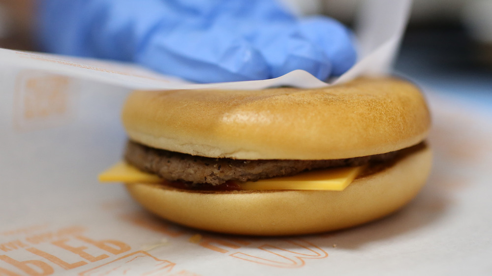 McDonald's cheeseburger being wrapped