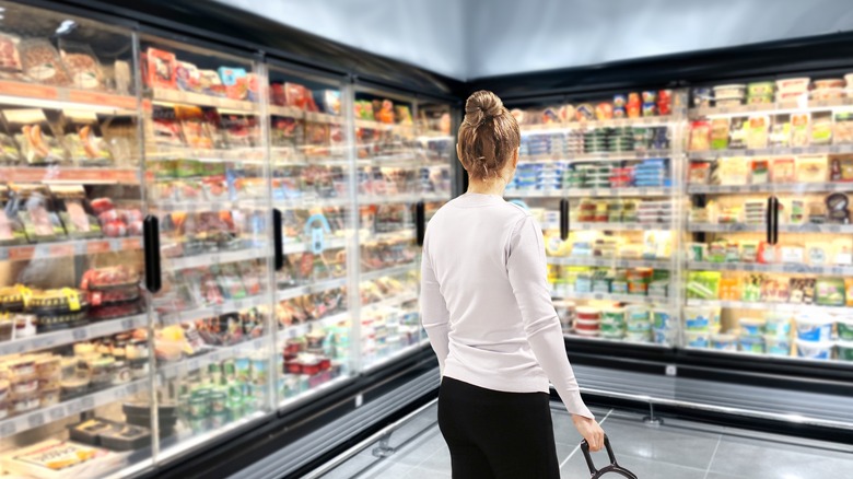 woman browsing frozen food aisle