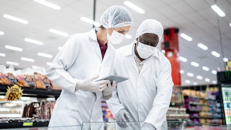 workers inspecting in supermarket 