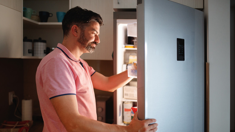 man opening freezer