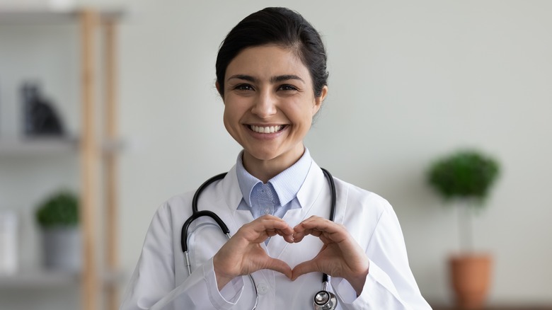 Cardiologist makes heart with hands