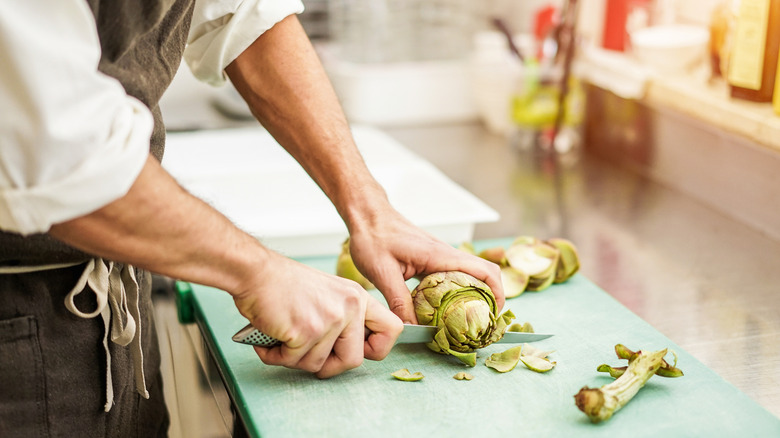 chef cuts artichokes