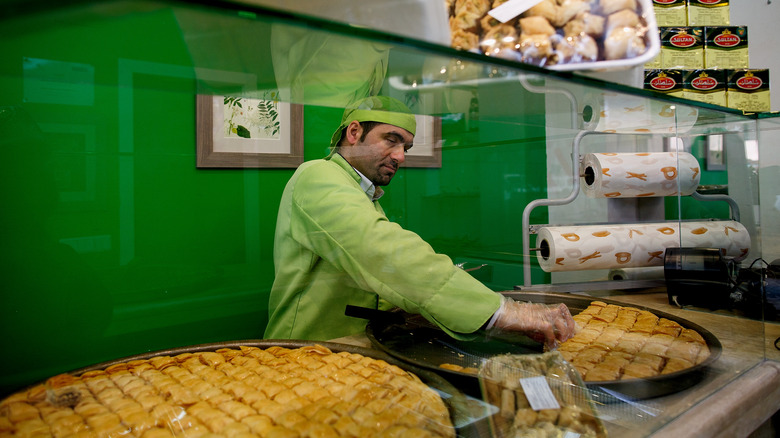 Man serves baklava 