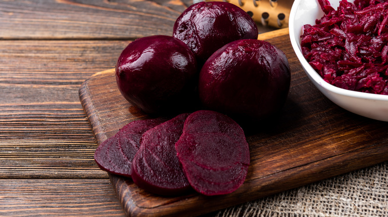 Cooked beetroot slices on wood cutting board