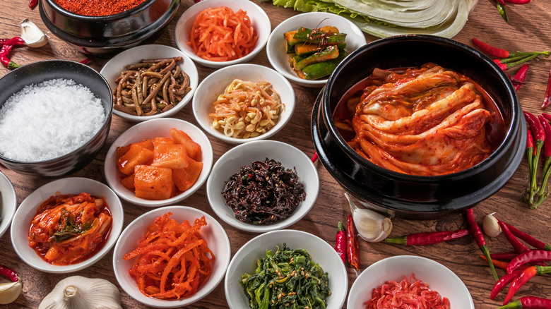 A series of white bowls full of ingredients on brown table