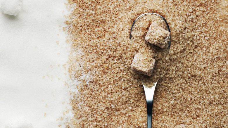 white sugar with brown sugar on spoon