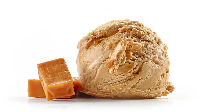 Scoop of ice cream alongside caramel squares