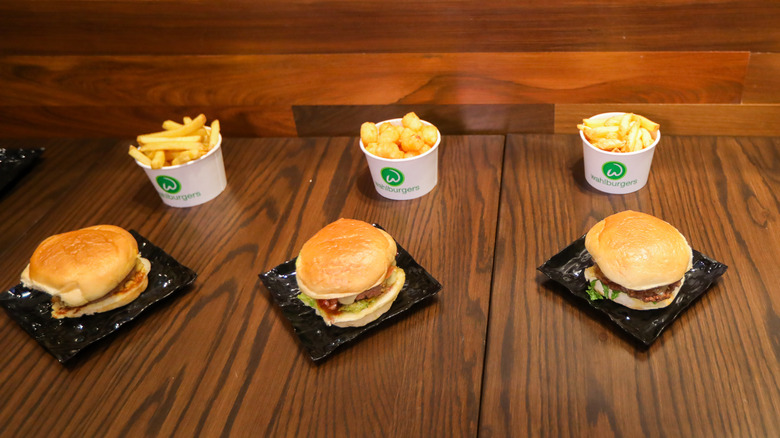 three wahlburgers hamburgers with fries