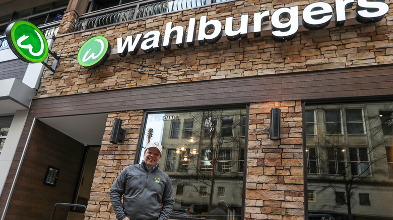 paul wahlberg in front of wahlburgers