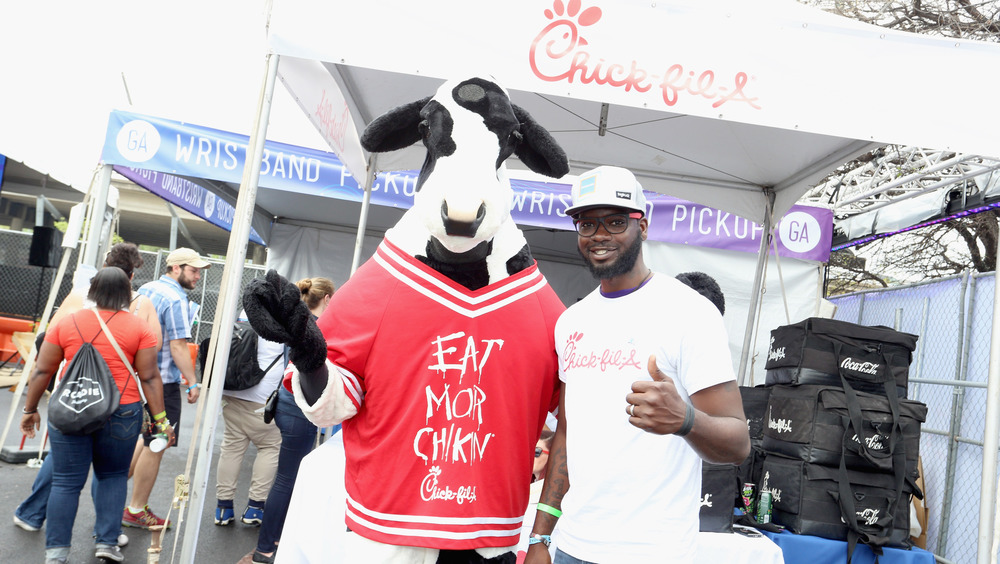Chick-fil-a cow and brand ambassador in front of restaurant