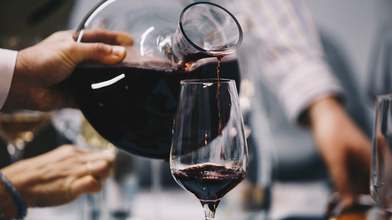 Pouring wine from a decanter into a glass