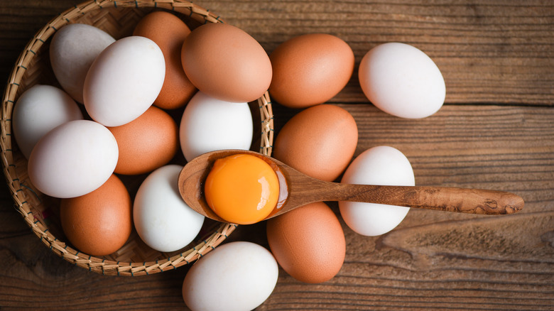 chicken and duck eggs in basket