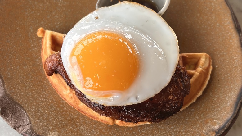 sunny side up duck egg with meat and waffle