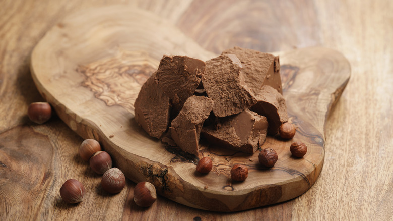 gianduja chocolate and hazelnuts on wooden board