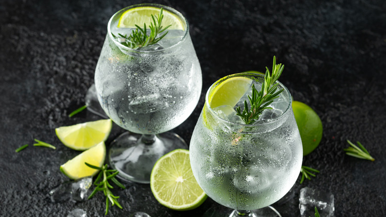 Gin and tonics served with rosemary and lime. 