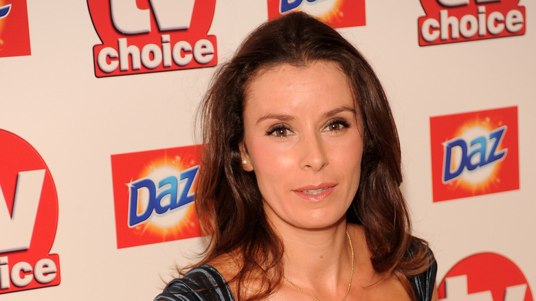 Tana Ramsay with slight smile on step and repeat