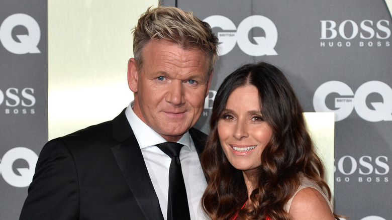 Tana and Gordon Ramsay smiling on the red carpet