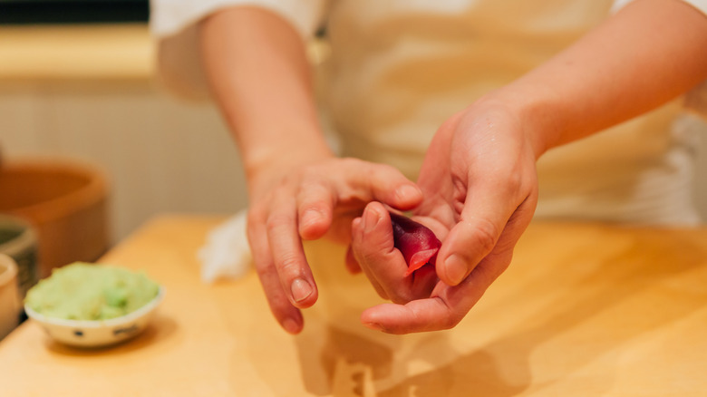 A chef hand-rolling sushi for kaiseki