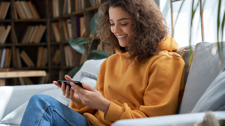 Young person watching content on smart phone 