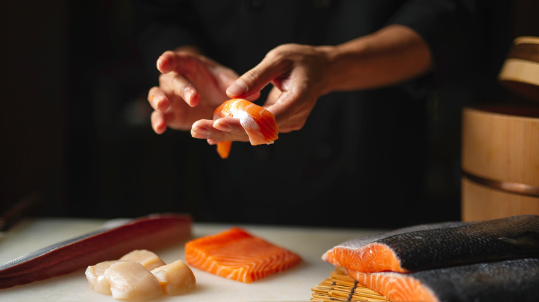 chef hands making sushi