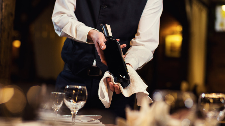 waiter showing wine bottle