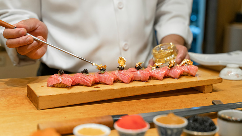 chef garnishing sushi