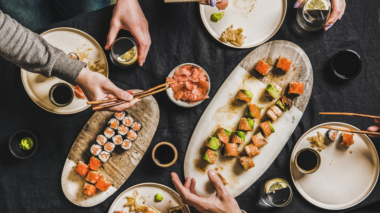 people eating sushi from above