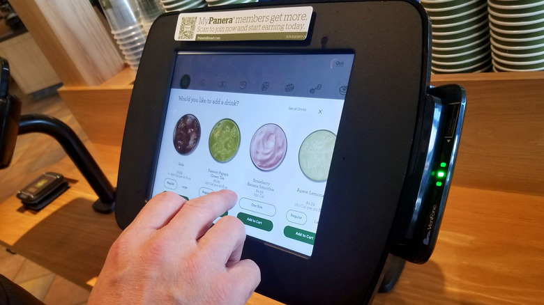 customer ordering at Panera kiosk