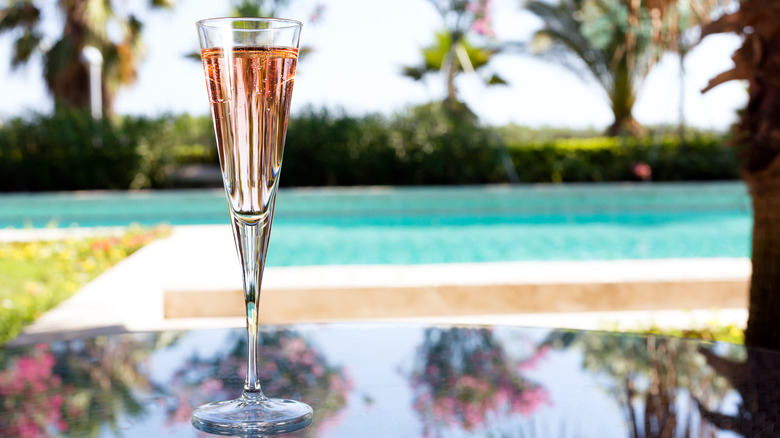 Glass of Prosecco rosé by a pool