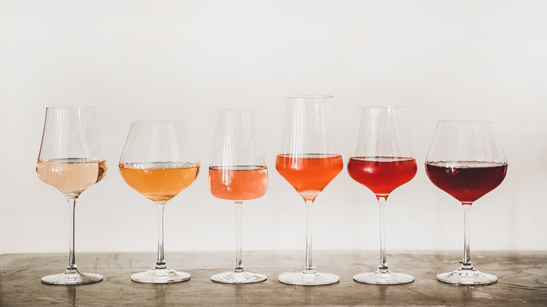 Several different rosé wines lined up by color. 