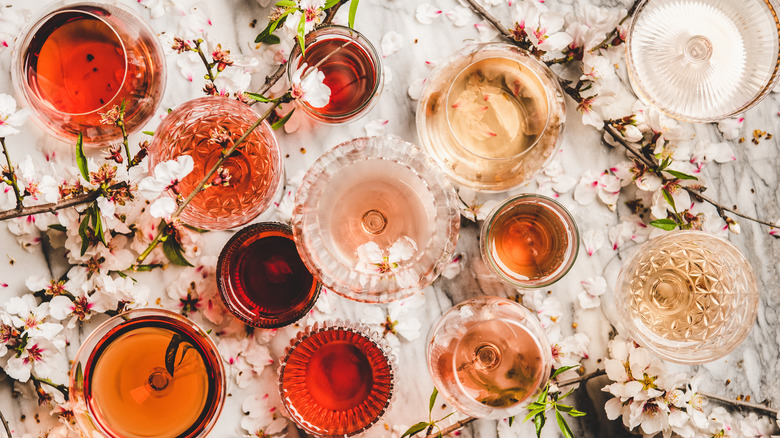 Several glasses of rosé wine on a table. 