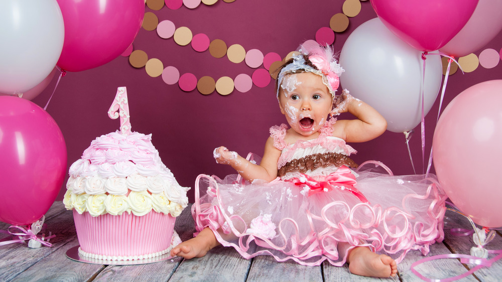 baby girl and smash cake