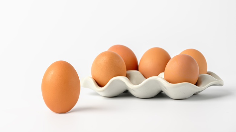 Brown eggs on white background