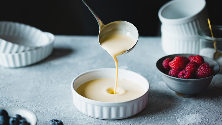 Pouring custard into ramekins