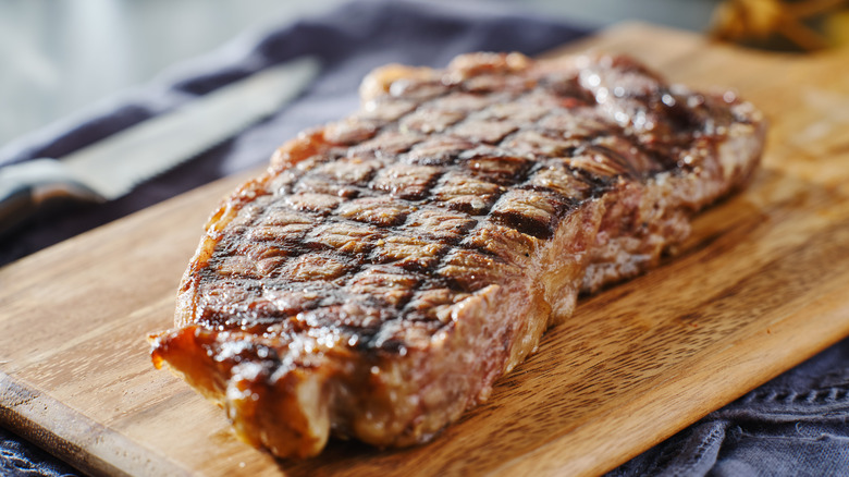 resting steak on cutting board