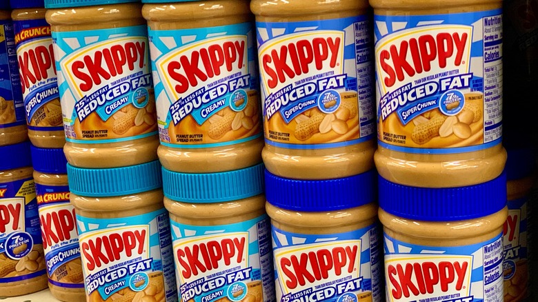 jars of skippy reduced fat peanut butter on store shelf