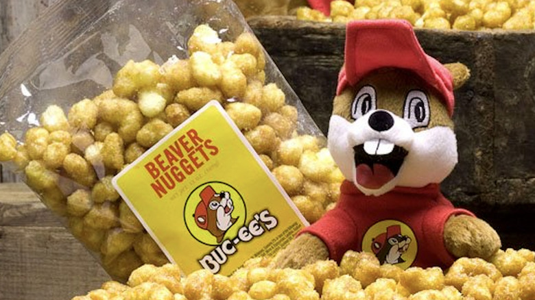 Buc-ee's beaver with a bag of Beaver Nuggets