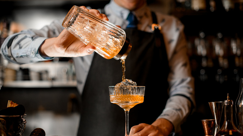 Person pouring a cocktail