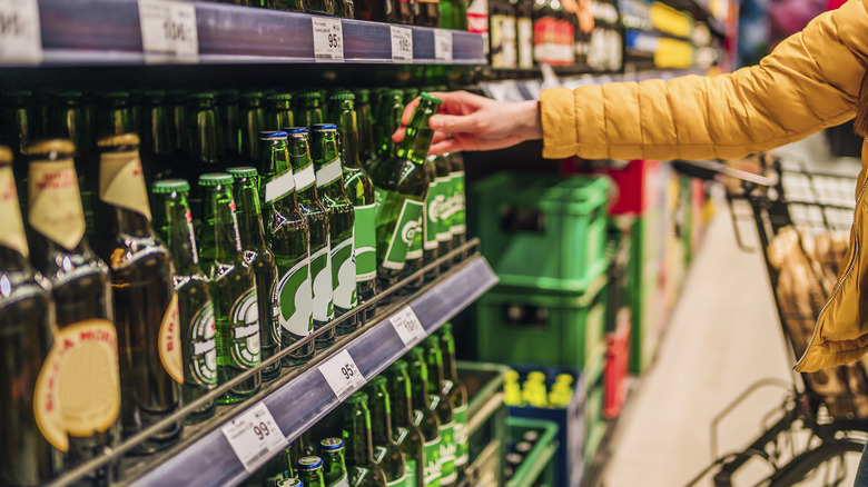 Person selecting beer in store