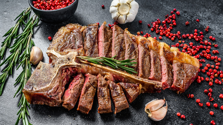 Cooked T-bone steak sliced with berries