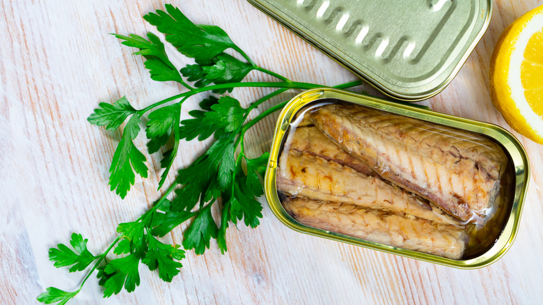 open can of mackerel with parsley and lemon