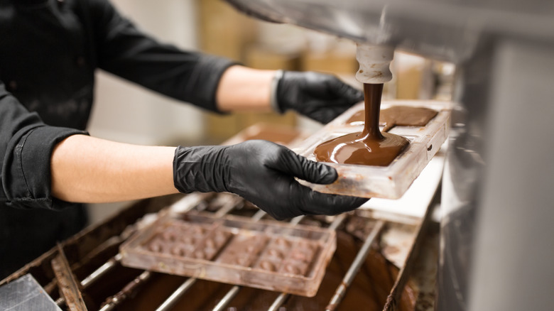 worker filling chocolate mold