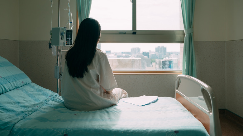 Person sitting on hospital bed