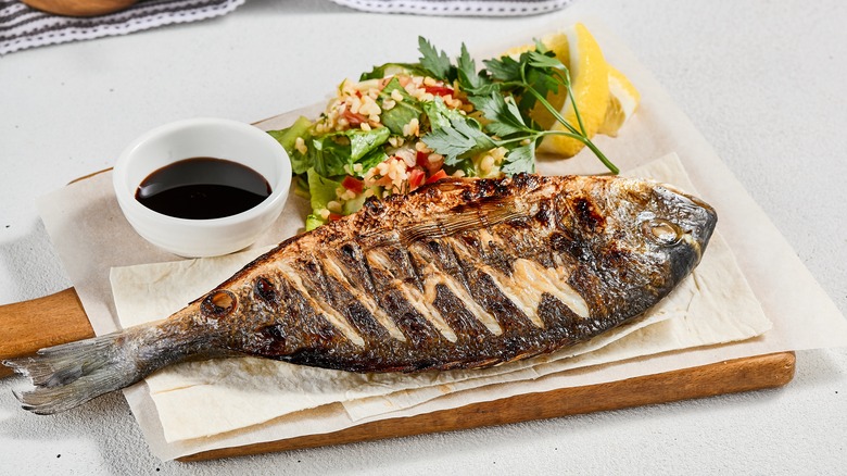 grilled fish on wooden plank