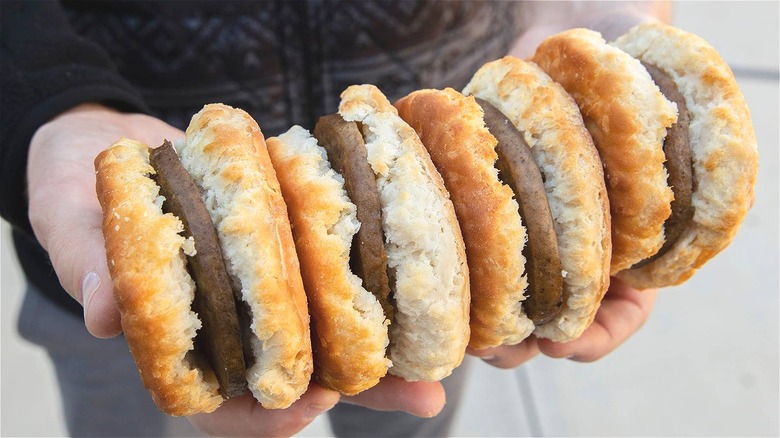 Person holding Hardee's sausage biscuits