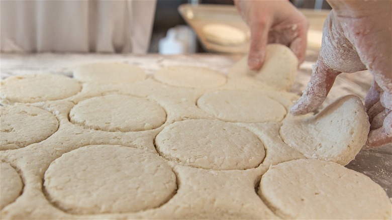 Baker with raw biscuit dough