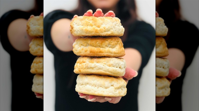 Person holding stacked butter biscuits