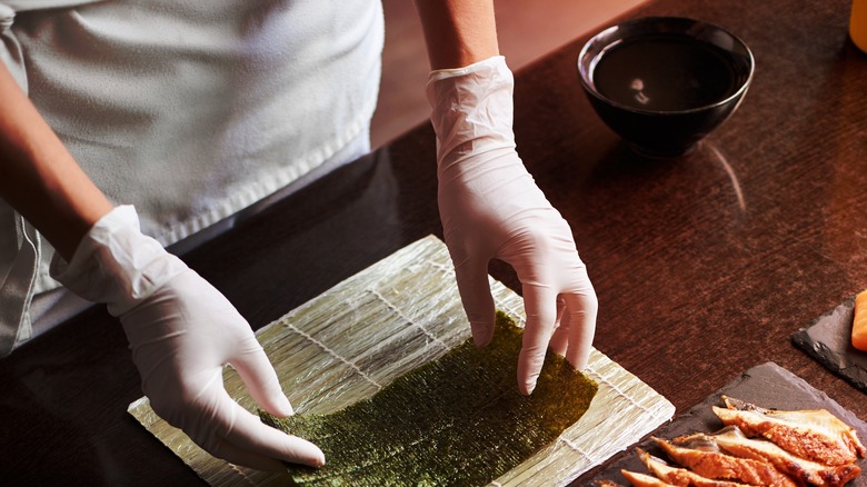 Preparing sushi with water bowl