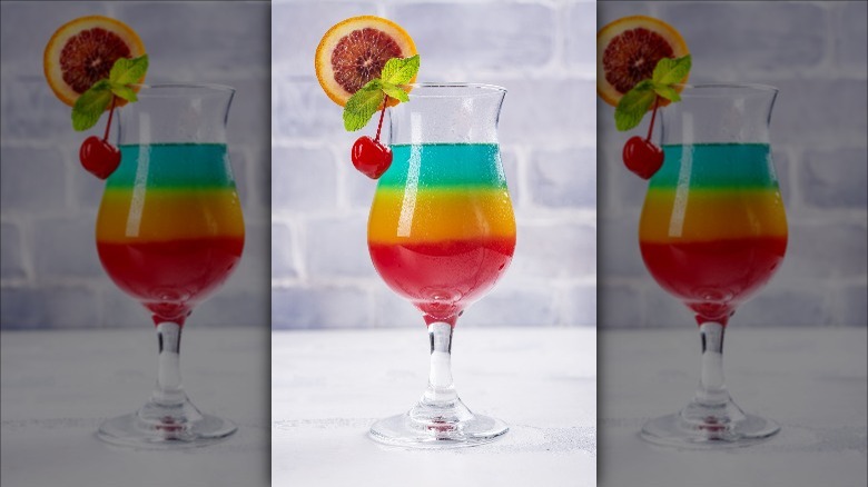 layered cocktail with fruit garnish